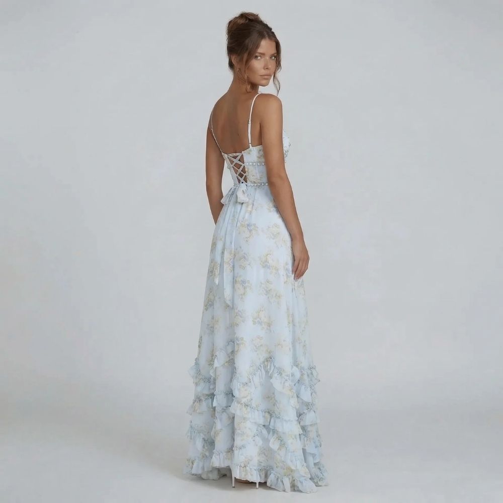 White floral maxi dress with bow detail on lace-up back, side angle.